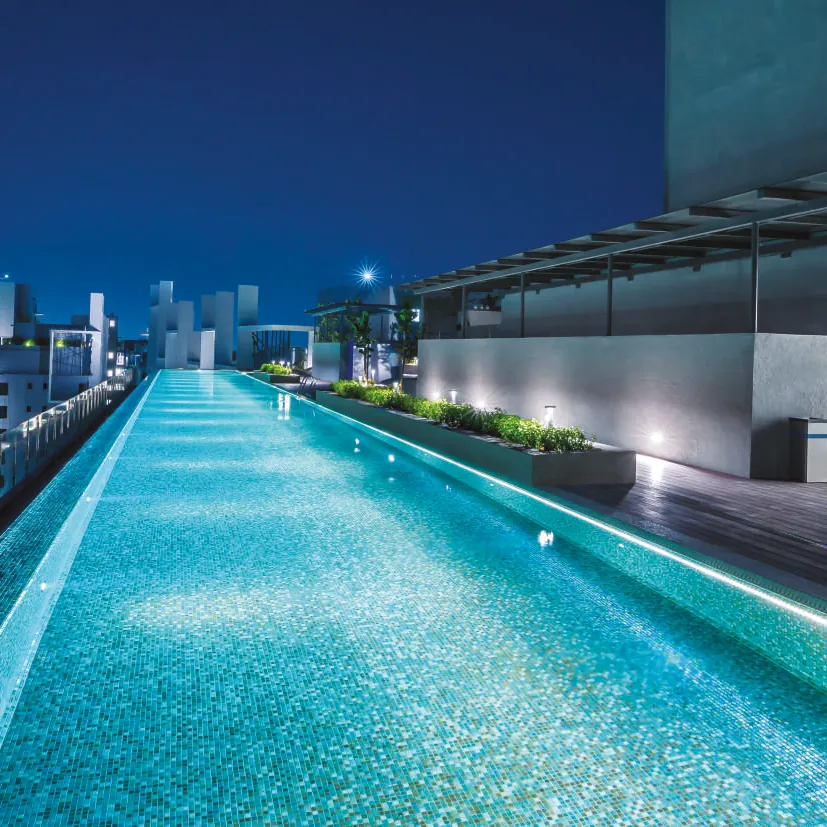 Infinity pool overlooking the city at night, representative of The Trilight Kokapet