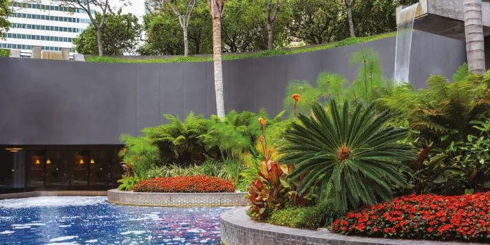 Landscaped garden with water features, representative of the grounds at The Trilight Kokapet
